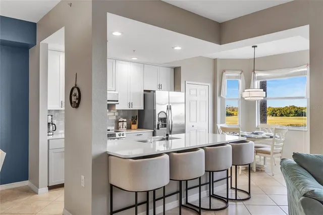 a kitchen with stainless steel appliances kitchen island granite countertop a sink and cabinets