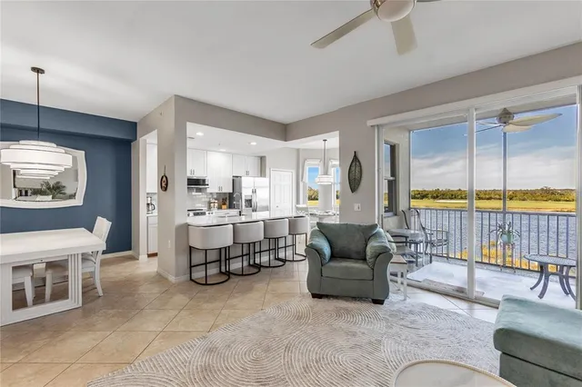a living room with furniture a rug and a chandelier