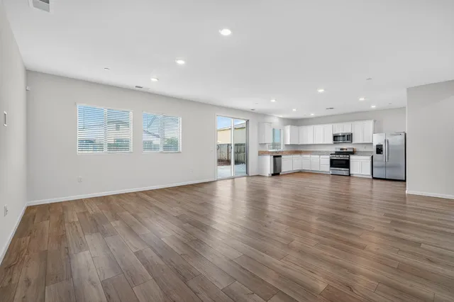 a view of kitchen with furniture and wooden floor