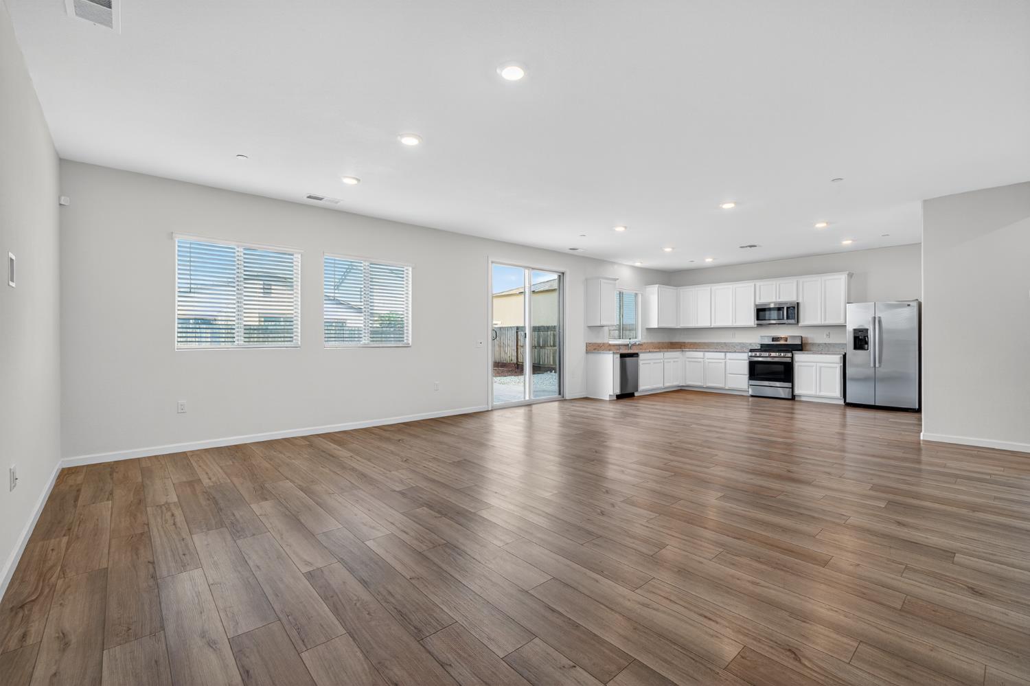 12829 Scholarly Way Rancho Cordova, CA 95742 - Photo 13 of 33 a view of kitchen with furniture and wooden floor