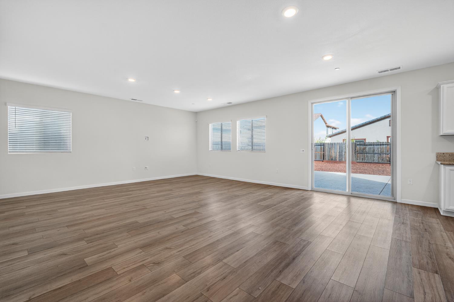 12829 Scholarly Way Rancho Cordova, CA 95742 - Photo 15 of 33 a view of empty room with wooden floor and fan