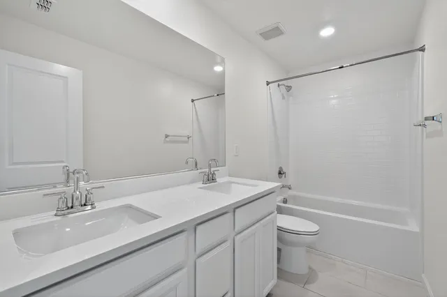 a bathroom with a shower sink vanity and mirror