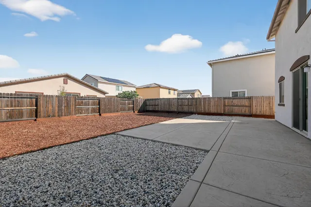 a front view of a house with plants