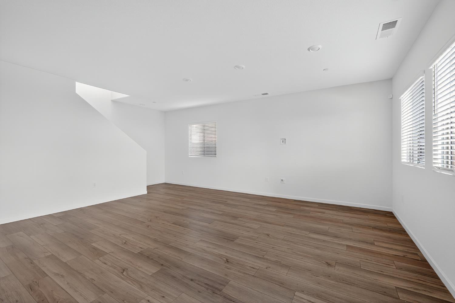 12829 Scholarly Way Rancho Cordova, CA 95742 - Photo 5 of 33 a view of an empty room with wooden floor and a window