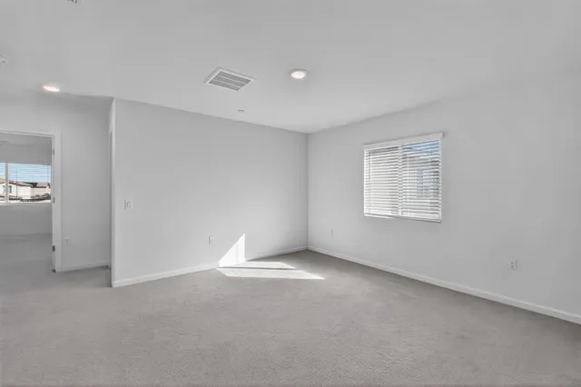 an empty room with a empty space and windows