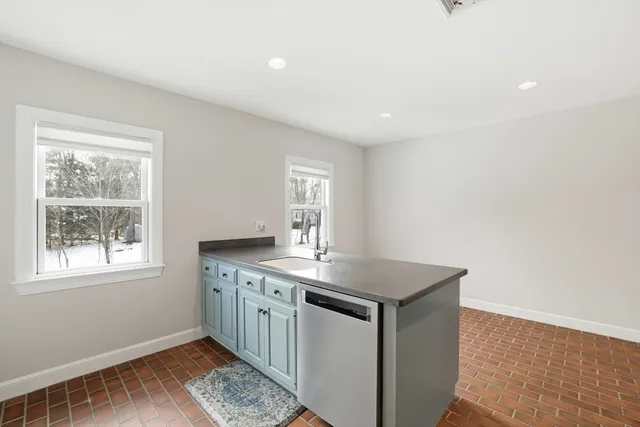 a room with a sink cabinets and wooden floor