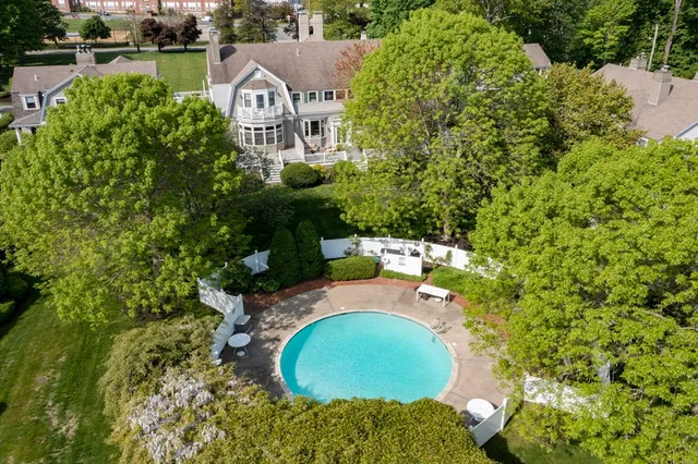 an aerial view of a house with yard swimming pool and outdoor seating
