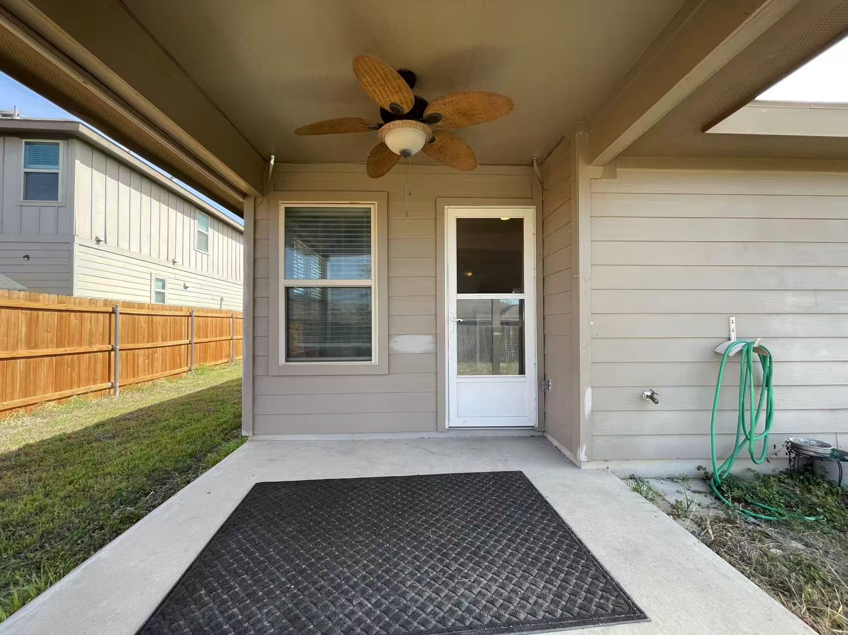 457 Dragon Ridge Road Buda, TX 78610 - Photo 19 of 29 Doorway to property with a ceiling fan and a patio