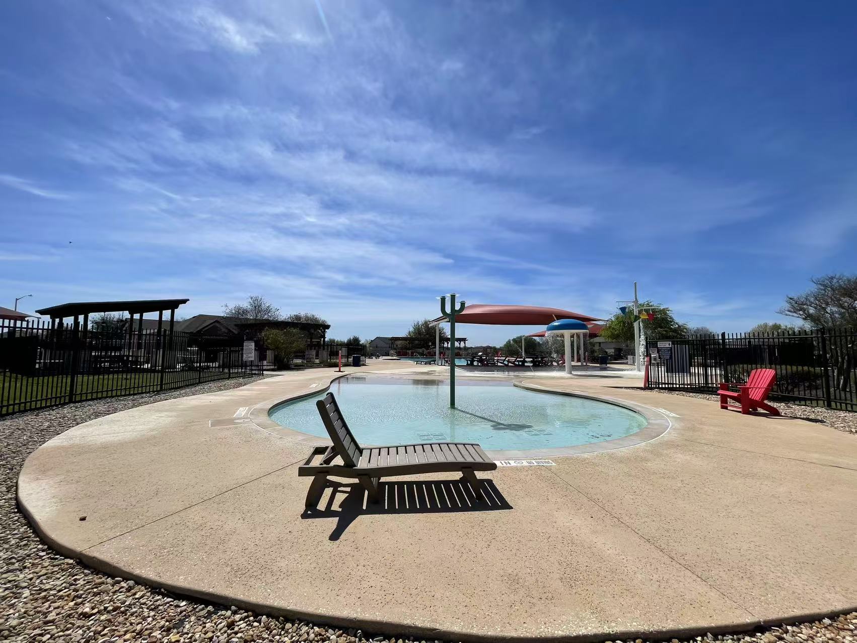 457 Dragon Ridge Road Buda, TX 78610 - Photo 27 of 29 Community pool featuring a patio and a water play area