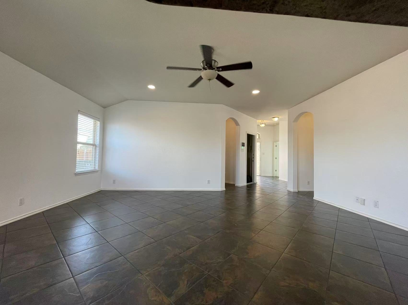 457 Dragon Ridge Road Buda, TX 78610 - Photo 9 of 29 Unfurnished room featuring a ceiling fan, vaulted ceiling, and recessed lighting