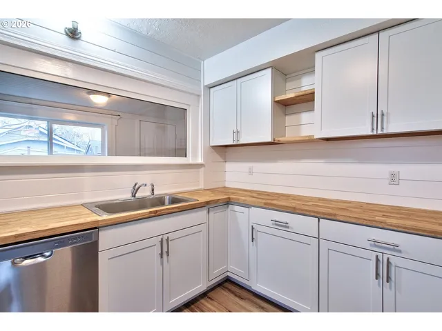 a kitchen with a sink and cabinets