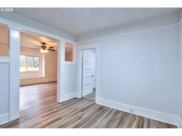 wooden floor in an empty room and a window