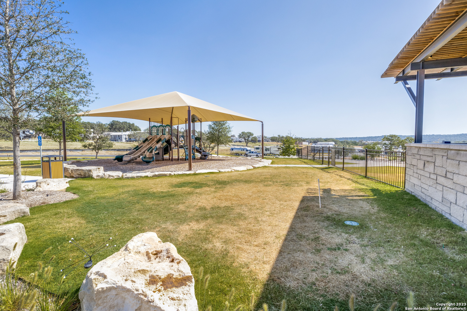 5386 Ranch Road 1376 Fredericksburg, TX 78624 - Photo 6 of 30 a view of a swimming pool with a table and chairs under an umbrella