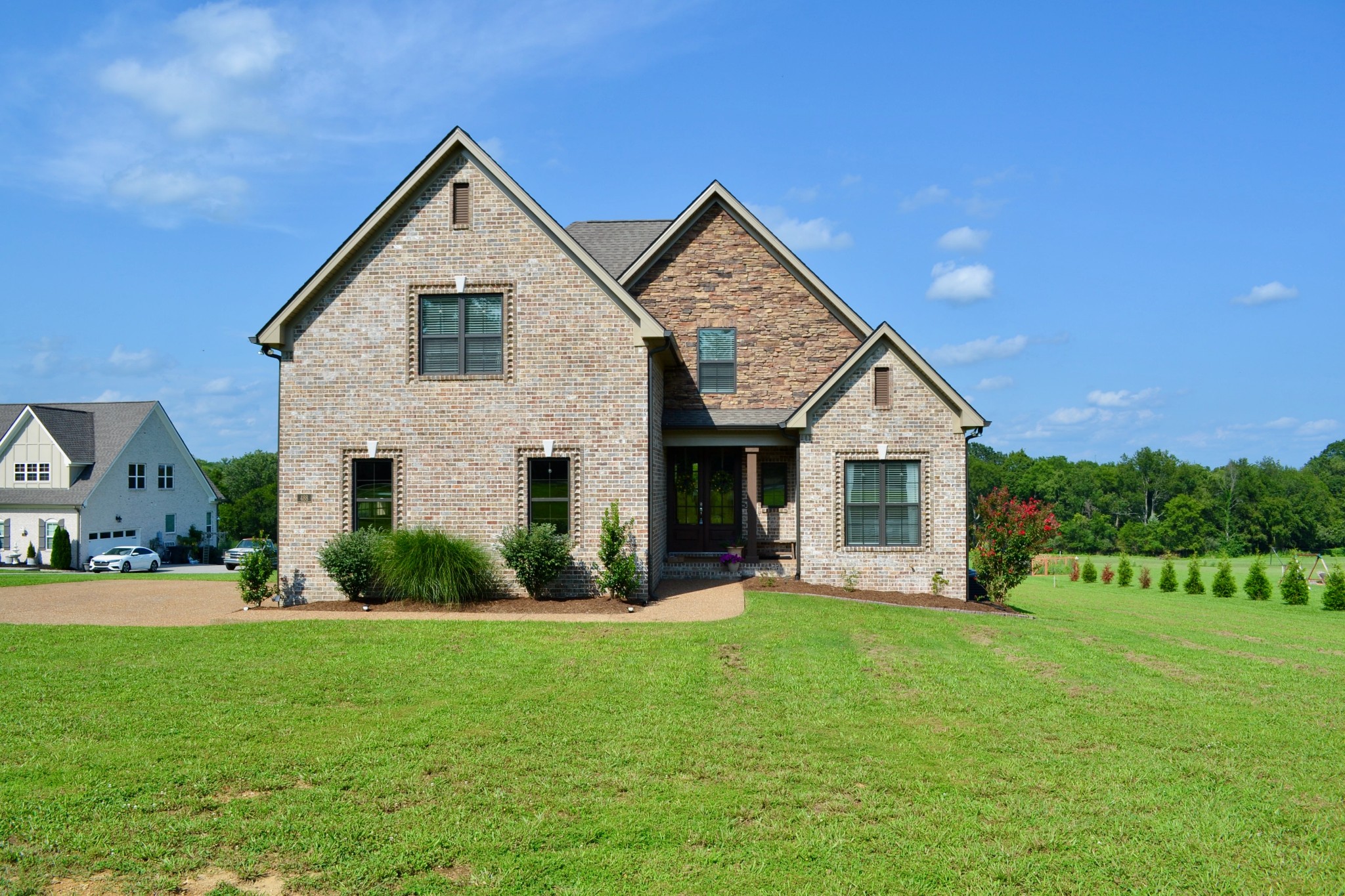 a front view of house with yard and green space