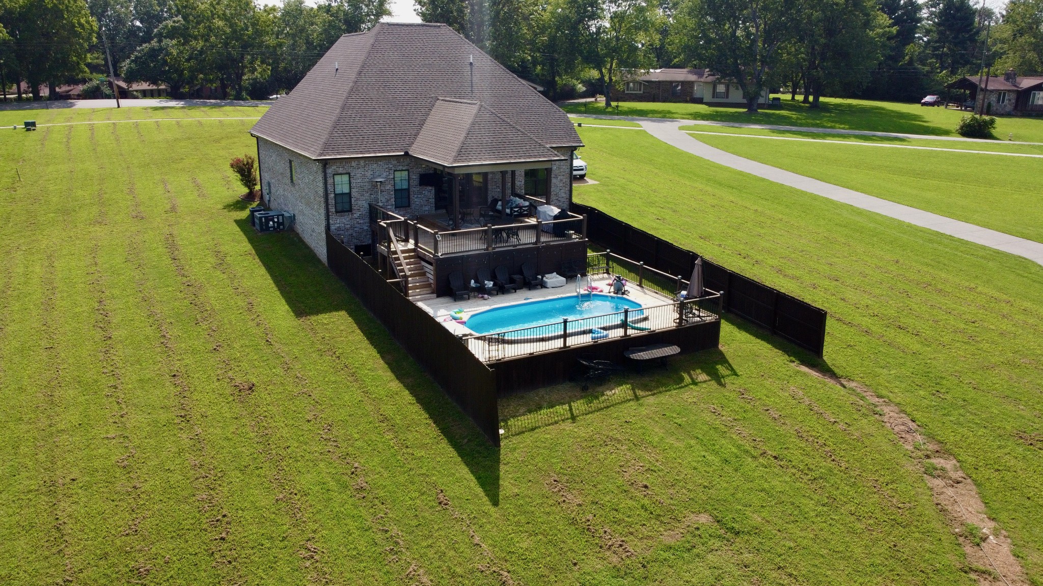 488 Cole's Ferry Road Gallatin, TN 37066 - Photo 10 of 43 a small pool with lawn chairs under an umbrella