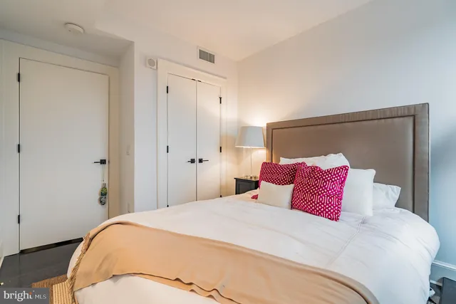 a bedroom with a bed and a lamp