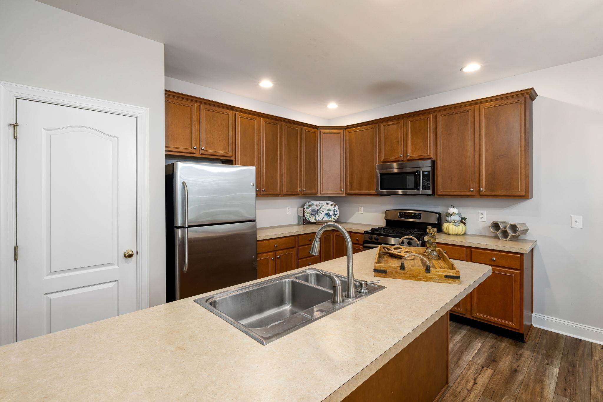 9510 Lost Key Court Raleigh, NC 27617 - Photo 19 of 46 a kitchen with a refrigerator a stove a sink a cabinets and wooden floor