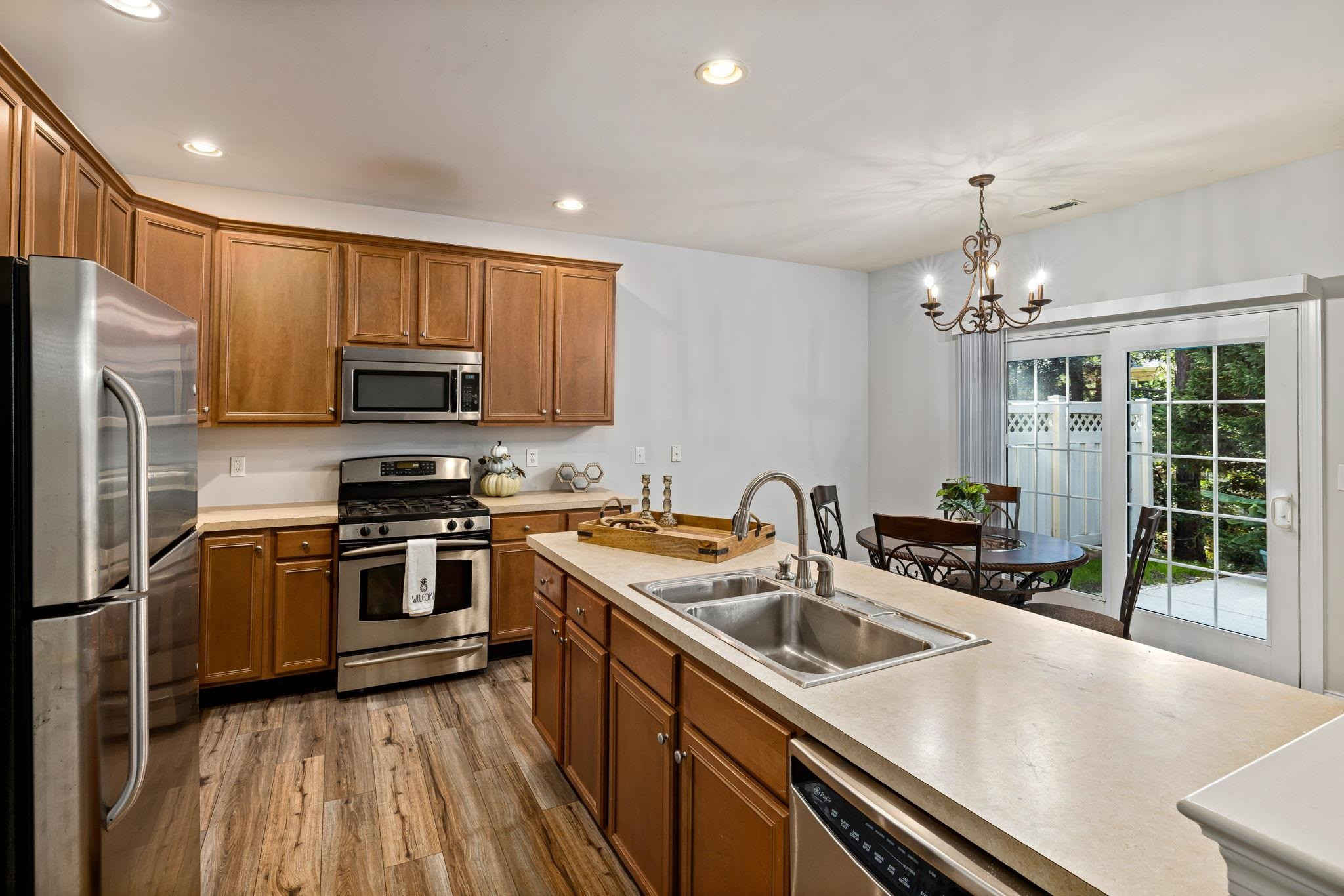 9510 Lost Key Court Raleigh, NC 27617 - Photo 20 of 46 a kitchen that has a sink stainless steel appliances and cabinets