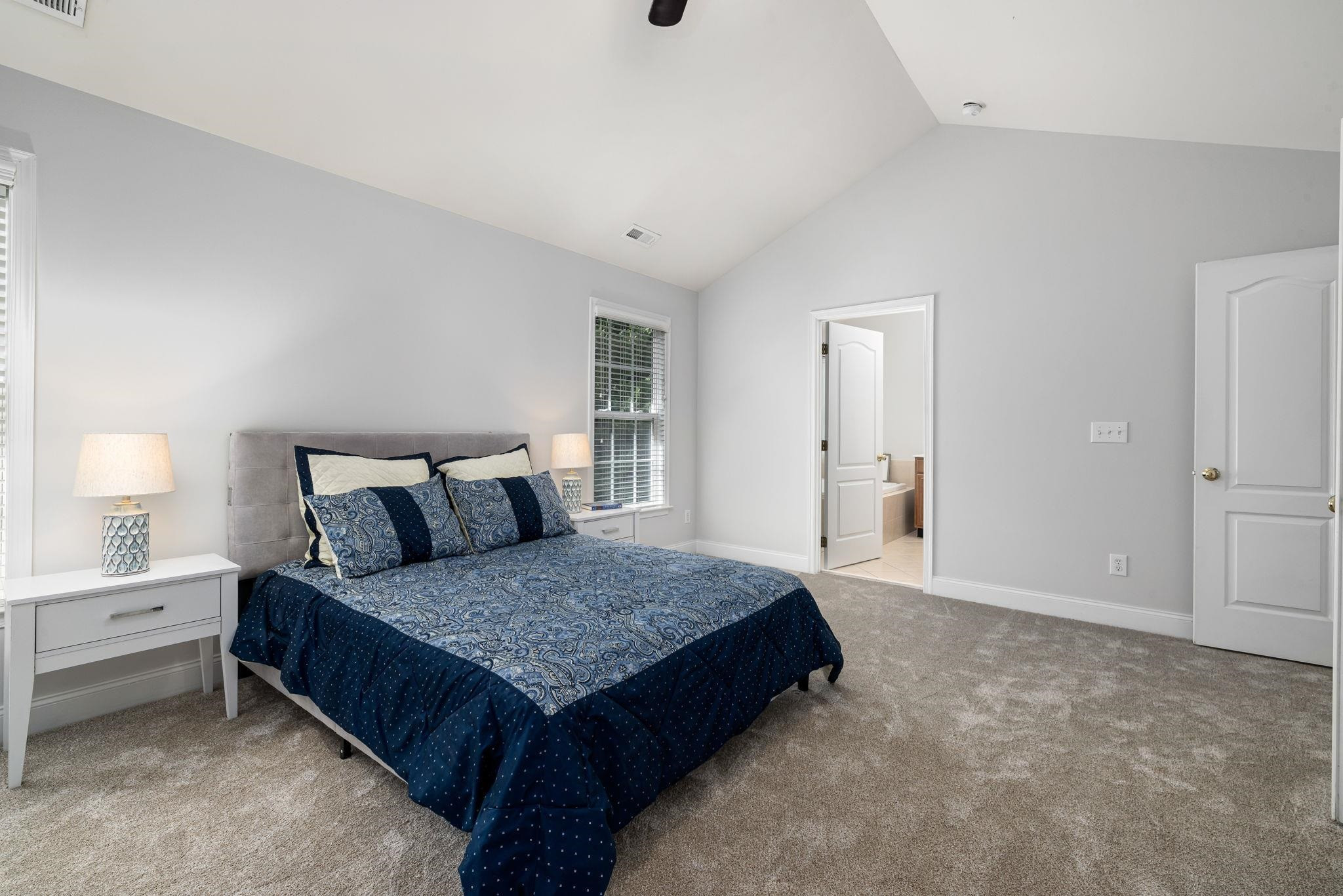 9510 Lost Key Court Raleigh, NC 27617 - Photo 33 of 46 a spacious bedroom with a bed and a lamp