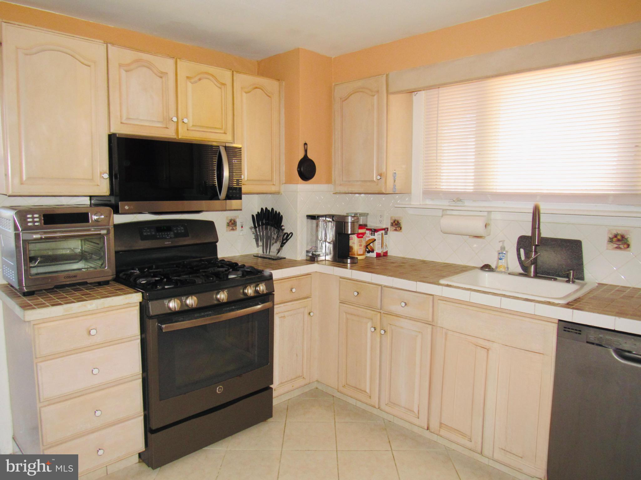306 South State Road Upper Darby, PA 19082 - Photo 16 of 58 a kitchen with white cabinets and appliances