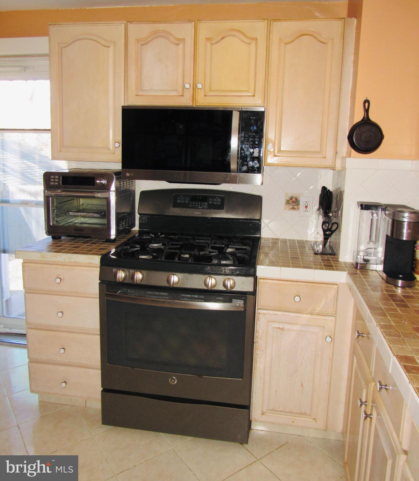 306 South State Road Upper Darby, PA 19082 - Photo 18 of 58 a kitchen with a stove and a microwave
