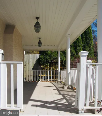 a view of a porch with a floor to ceiling window and stairs