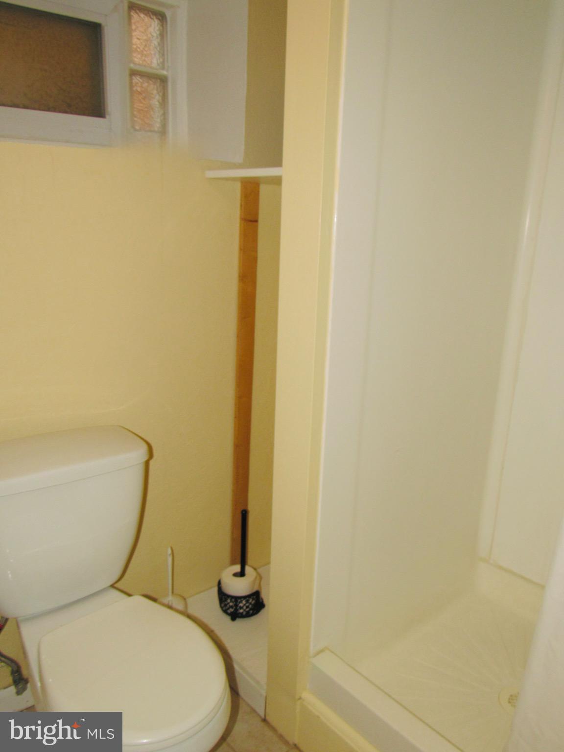 306 South State Road Upper Darby, PA 19082 - Photo 30 of 58 a white toilet sitting next to a shower