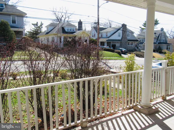 a view of a house with a small yard and wooden fence