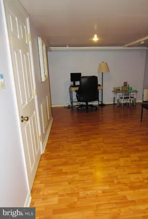 a view of a room with wooden floor and a chair