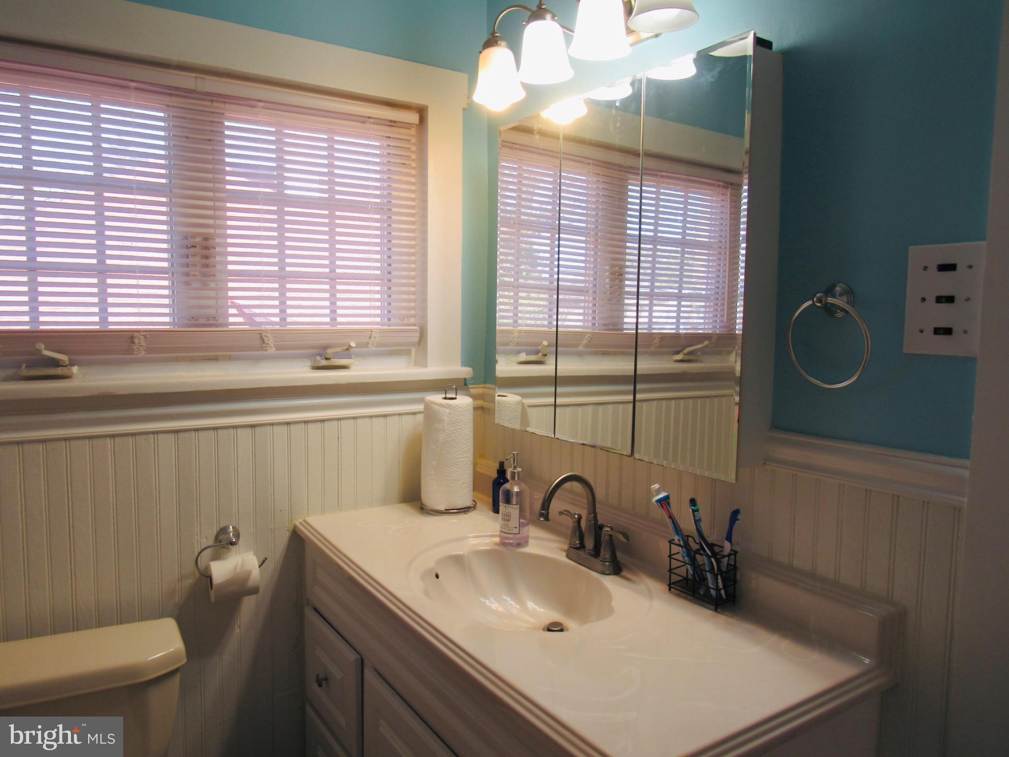 306 South State Road Upper Darby, PA 19082 - Photo 40 of 58 a bathroom with a sink a toilet and mirror