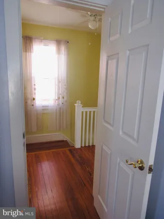 a room with a baby crib and a window