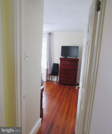 a view of a room with wooden floor and a window