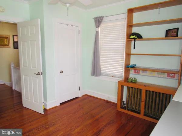 a backyard of a house with wooden floor and ceiling fan