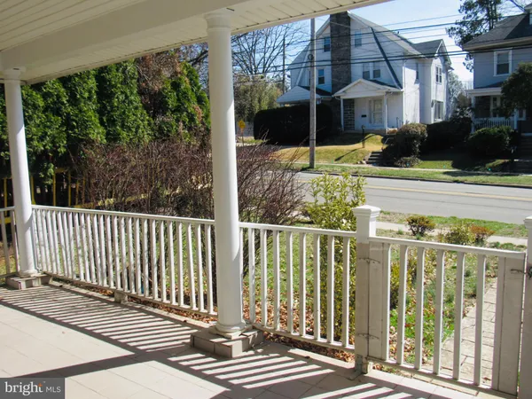 a view of a porch with wooden floor and iron fence