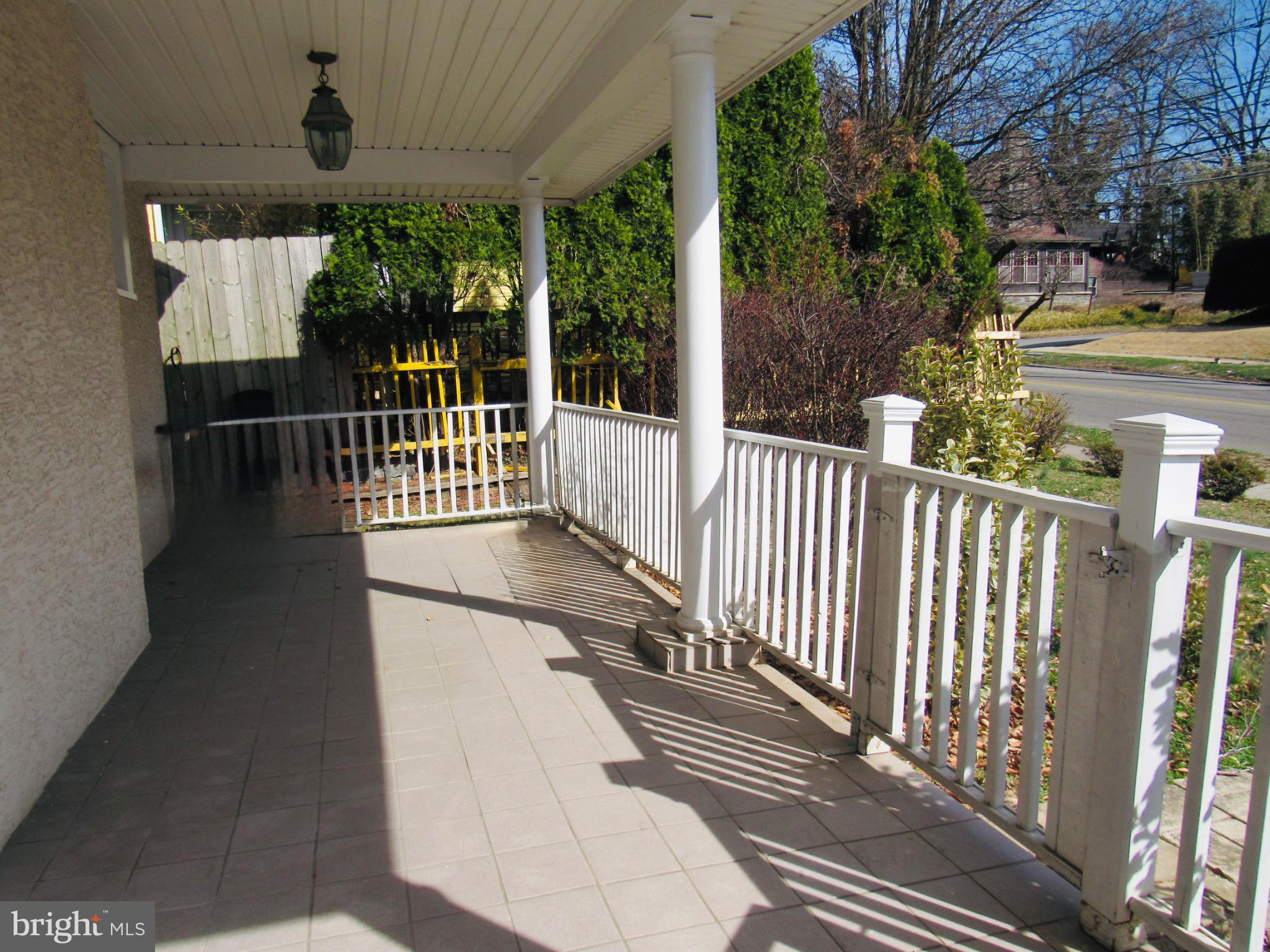 306 South State Road Upper Darby, PA 19082 - Photo 6 of 58 a view of a porch with wooden floor and iron fence