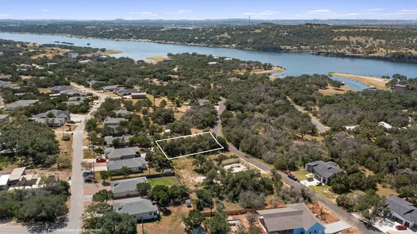 an aerial view of residential building with outdoor space and river