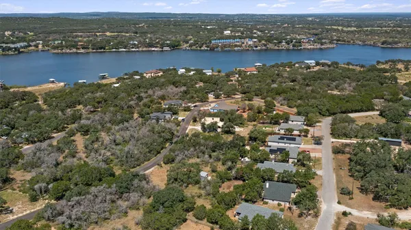 an aerial view of a houses with ocean view