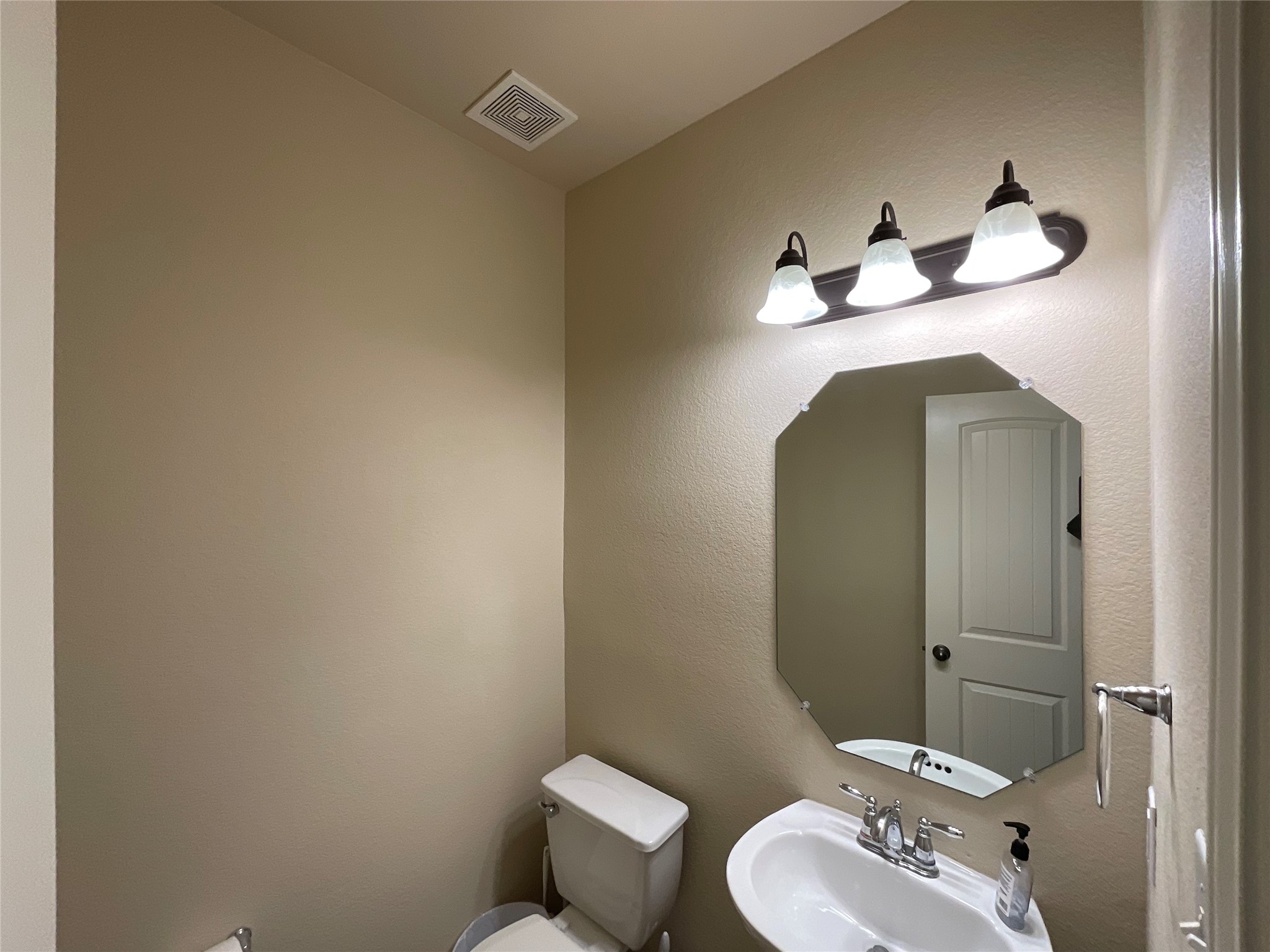1911 Conn Creek Road Cedar Park, TX 78613 - Photo 8 of 39 a bathroom with a toilet sink and mirror