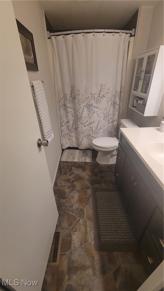 18592 Edwards Road Doylestown, OH 44230 - Photo 12 of 21 Full bathroom with toilet, vanity, and curtained shower