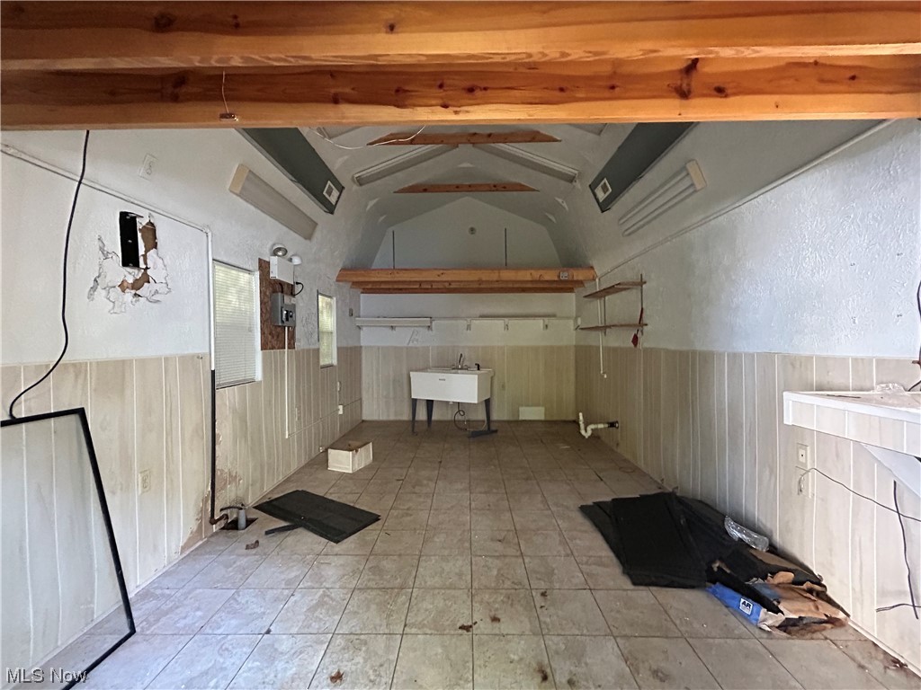 13604 Claiborne Road Cleveland, OH 44112 - Photo 18 of 18 out building featuring vaulted ceiling with beams and light tile flooring