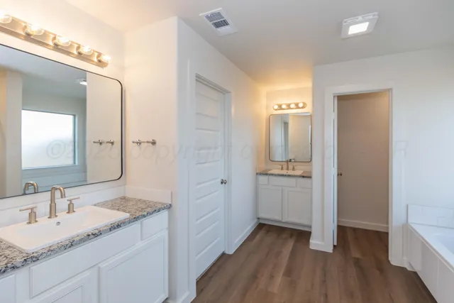 a spacious bathroom with a bathtub and a sink