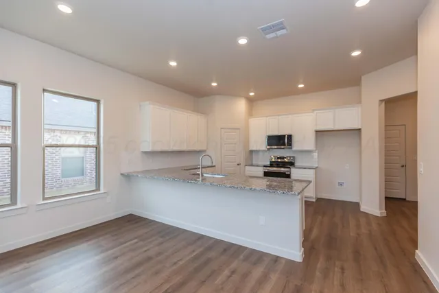 a kitchen with a sink stainless steel appliances and cabinets