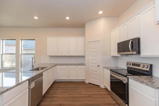 a bathroom with a sink toilet a mirror and vanity
