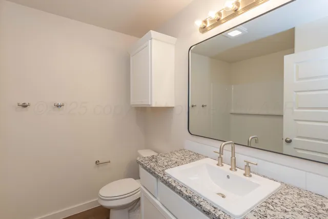 a bathroom with a tub shower and sink