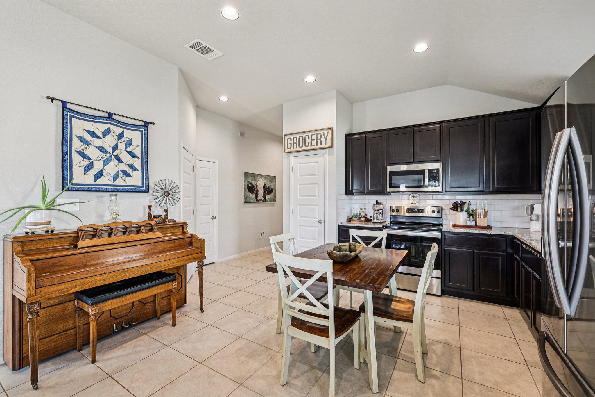 111 Insider Loop Elgin, TX 78621 - Photo 15 of 39 a kitchen with stainless steel appliances a stove a sink a microwave and a refrigerator