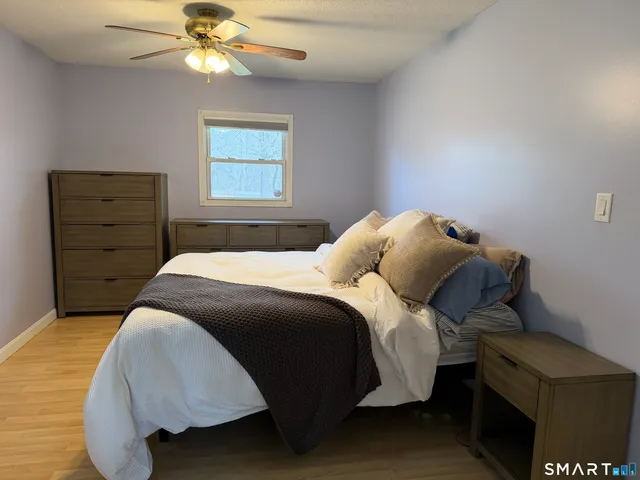 a bedroom with a bed and a window