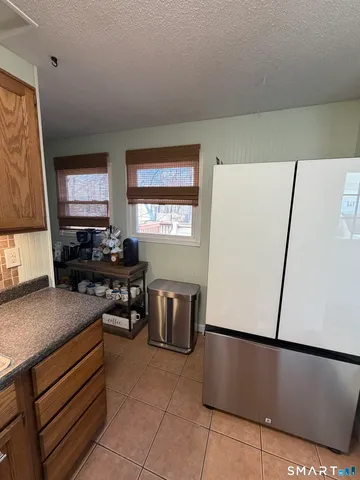 a kitchen with a refrigerator and a stove top oven