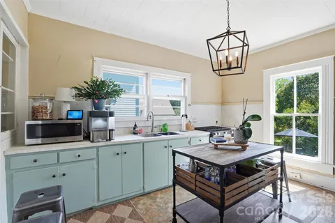 a kitchen with a stove a sink and a microwave