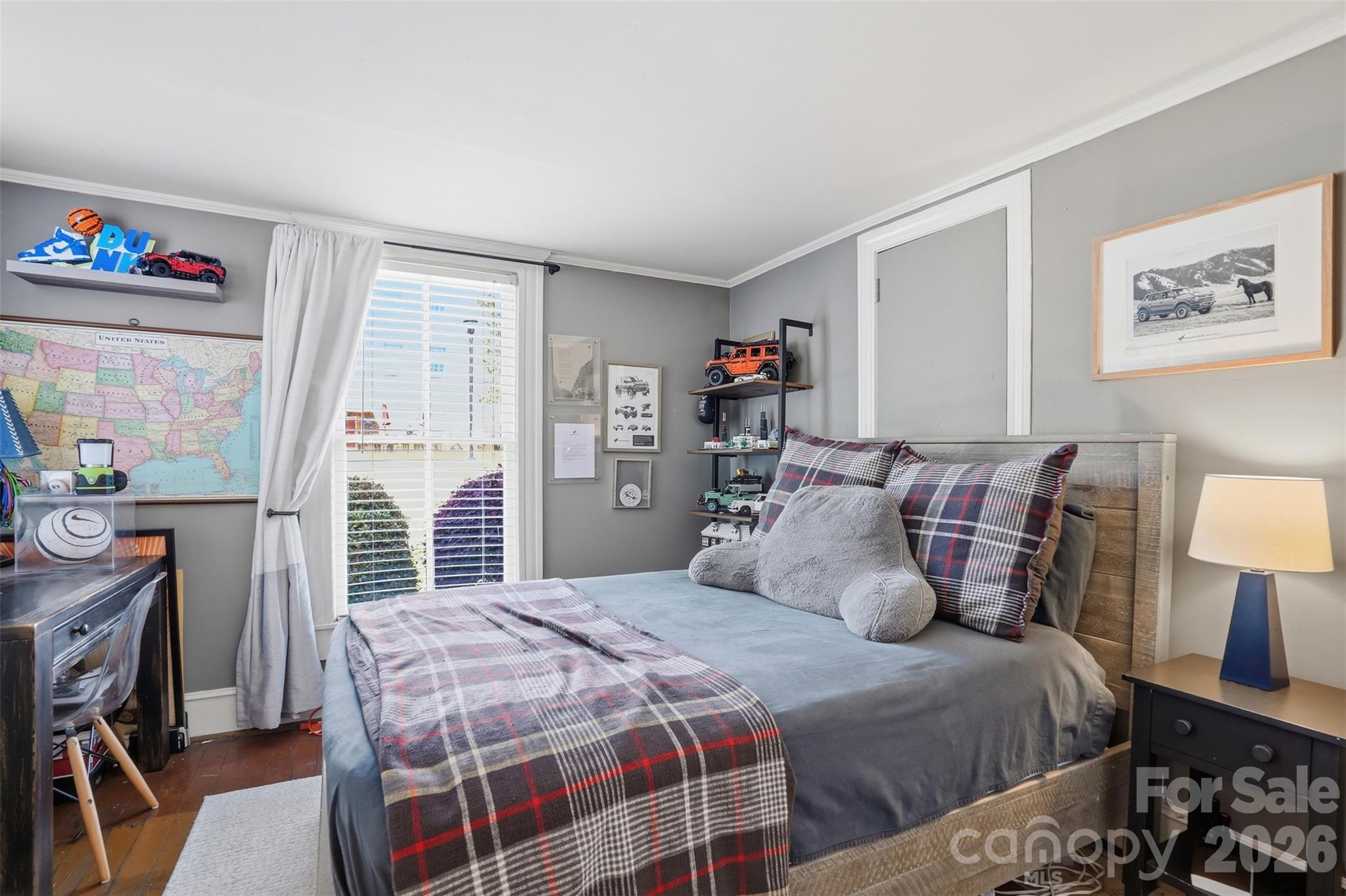 303 South Street Davidson, NC 28036 - Photo 18 of 37 a bedroom with a bed and a table in it with painting on the wall