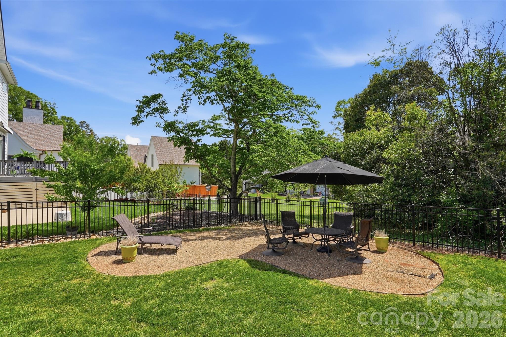 303 South Street Davidson, NC 28036 - Photo 25 of 37 a view of a backyard with sitting area and slide
